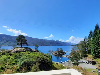 a view of a lake with mountains in the background at Holiday Home Häuschen mit Blick auf das Wasser by Interhome in Ropeid