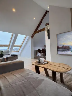 a living room with a couch and a coffee table at Modern 3-bedroom apartment with a view in Trondheim