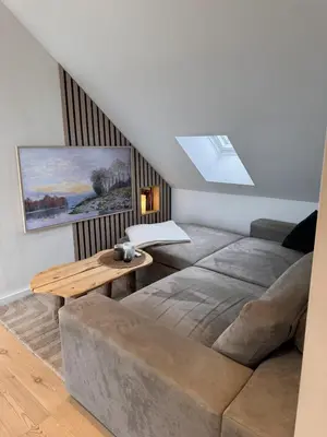 a living room with a couch and a table at Modern 3-bedroom apartment with a view in Trondheim