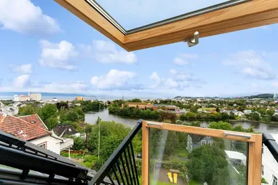 a balcony with a view of a river at Modern 3-bedroom apartment with a view in Trondheim