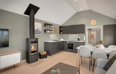 a kitchen and dining room with a fireplace at Exclusive mountain cabin - Panoramic views in Vossevangen