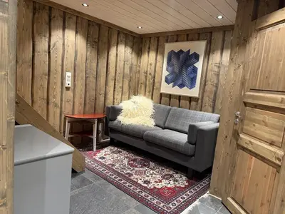 a living room with a couch and a table at Large cottage with beautiful view in Trysil in Trysil