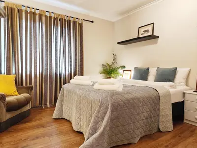 a bedroom with a large bed and a window at Women Only - Guestroom in centre of Førde town in Førde