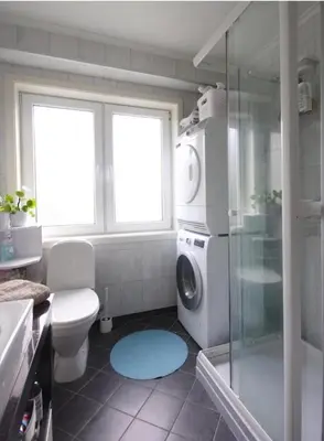 a bathroom with a shower and a washing machine at Women Only - Guestroom in centre of Førde town in Førde