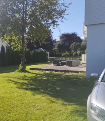 a park with a bench and a tree at Women Only - Guestroom in centre of Førde town in Førde