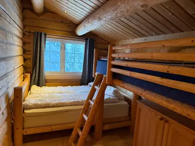 a bedroom with a bunk bed in a log cabin at Cabin at Fageråsen - 4 roomed family cabin for skiing in Trysil in Trysil