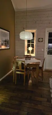 a dining room with a table and chairs and a chandelier at Apartment Røldalsfjellet in Håra