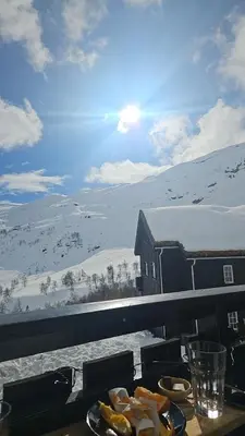 a table with plates of food on top of a snow covered mountain at Apartment Røldalsfjellet in Håra