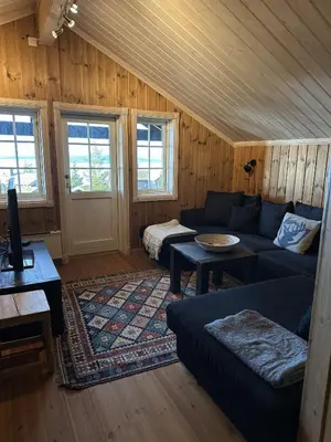 a living room with a couch and a table at Exclusive family cabin in Hafjell ski-in-ski-out in Hafjell