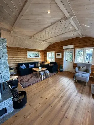 a living room with a couch and a fireplace at Exclusive family cabin in Hafjell ski-in-ski-out in Hafjell