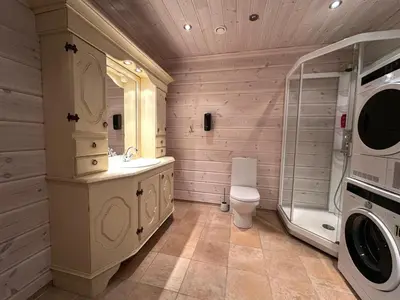 a bathroom with a sink and a washing machine at Botn Fjellstue in Botn