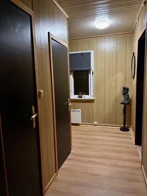 an empty hallway with a door and a window at Magic Cabin by Lake & Forest , Peace, Views & Outdoor Fun, in Opphus