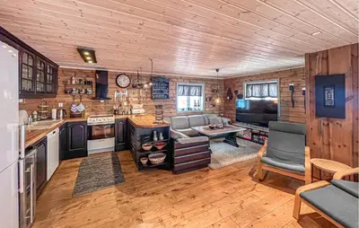 a kitchen with a couch and a table in a room at Awesome Home In Gålå With Sauna in Gålå
