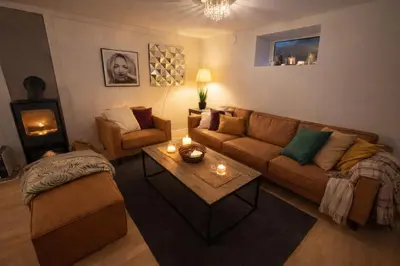 a living room with a couch and a table at Spacious 3 Bedroom Basement Apartment with Parking, Close to Trondheim City Center in Trondheim