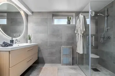 a bathroom with a shower and a sink and a mirror at Spacious 3 Bedroom Basement Apartment with Parking, Close to Trondheim City Center in Trondheim