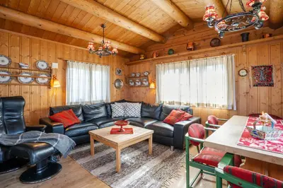 a living room with a couch and a table at Rundetjødn 20 in Hol