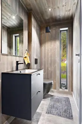 a bathroom with a sink and a black tub at New and great cabin at the foot of Norefjell in Noresund