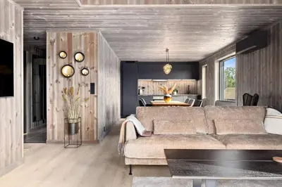 a living room with a couch and a table at New and great cabin at the foot of Norefjell in Noresund