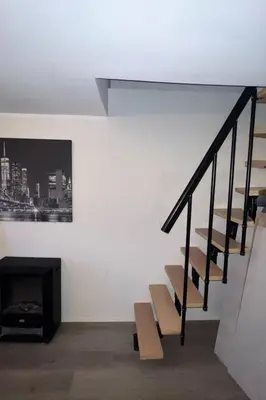 a living room with stairs and a fireplace at Central Bergen Stay for Families & Groups-6 Guests in Bergen