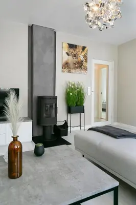 a bedroom with a bed and a tv and a fireplace at Centrum apartment 2 in Ålesund