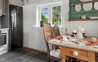 a kitchen with a wooden table with candles on it at 2 Bedroom Gorgeous Home In Svingvoll in Svingvoll