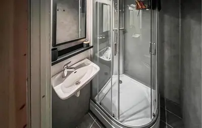 a bathroom with a sink and a shower at 2 Bedroom Awesome Home In Vanvikan in Vannvikan