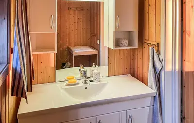 a bathroom with a sink and a mirror at 2 Bedroom Awesome Home In Vanvikan in Vannvikan