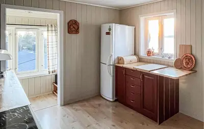 a kitchen with a refrigerator and a counter and a window at 2 Bedroom Awesome Home In Vanvikan in Vannvikan