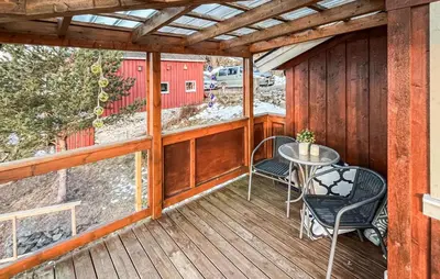 a wooden deck with a table and chairs on it at 2 Bedroom Awesome Home In Vanvikan in Vannvikan