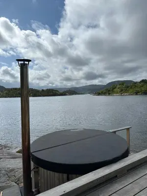 a table on a dock on a body of water at Amundøya Seaside in Kristiansund