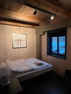 a small bed in a room with a window at Amundøya Seaside in Kristiansund