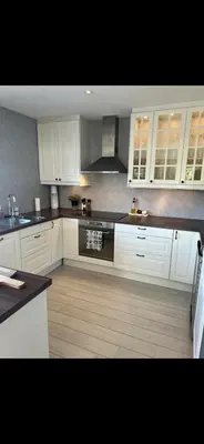 a kitchen with white cabinets and an oven at Koselig bolig med stor stue, 10 min from Solsiden! in Trondheim