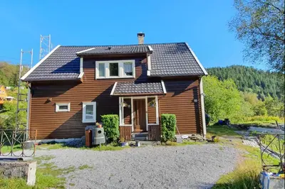 a wooden house with a solar roof on top at Bedroom with private living room in Bergen