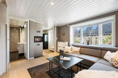 a living room with a couch and a table at Historic Bergen House with Sunny Terrace in Bergen