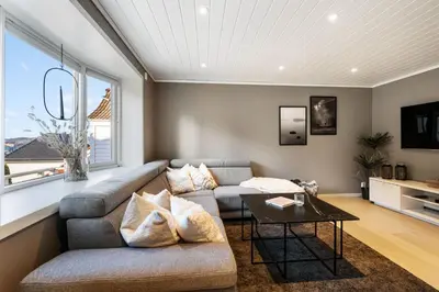a living room with a couch and a table at Historic Bergen House with Sunny Terrace in Bergen