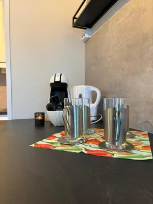 a table with two cups on top of a table at Midt i Raufoss, stor leilighet med hage in Raufoss