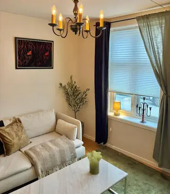 a living room with a couch and a window at 2 bedroom apartment historical downtown by the sea in Ålesund