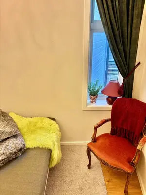 a living room with a couch and a chair and a window at 2 bedroom apartment historical downtown by the sea in Ålesund