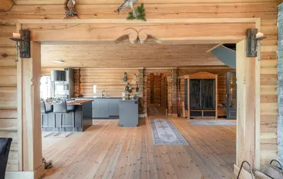 a large kitchen with wooden walls and wooden floors at 5 Bedroom Beautiful Home In Tuddal in Tuddal