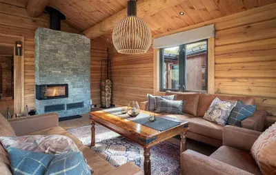 a living room with a couch and a fireplace at 5 Bedroom Beautiful Home In Tuddal in Tuddal