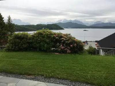 a view of a lake with mountains in the background at Solbakken, nice Apartment by the Sea in Ålesund in Ålesund