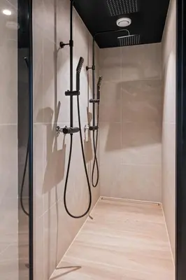 a bathroom with a shower with a glass door at Luxury Seafront Villa with Panoramic Views in Veland