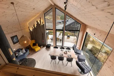 an overhead view of a living room with a table and chairs at Skarhaug Panorama Lodge in Stranda
