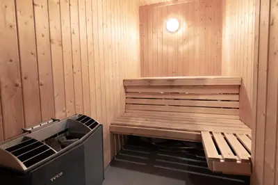 a sauna with a bench and a trash can at Bakkebyvegen 22A in Trysil