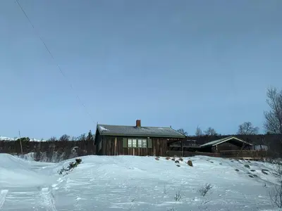 a house on top of a snow covered hill at Nedre Flaata Seter in Nørdstebø