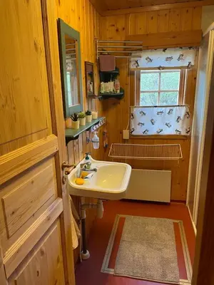 a bathroom with a sink and a window and a tub at Nedre Flaata Seter in Nørdstebø