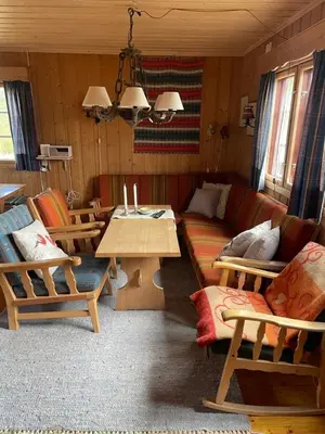 a living room with a couch and a table at Nedre Flaata Seter in Nørdstebø