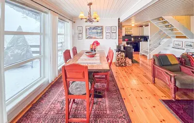 a dining room with a wooden table and chairs at 4 Bedroom Awesome Home In Rjukan in Rjukan