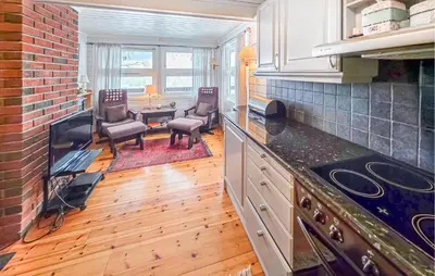 a kitchen with a counter and chairs and a table at 4 Bedroom Awesome Home In Rjukan in Rjukan