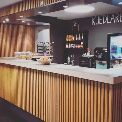 a counter in a restaurant with a bowl of food at Suldal Hotell in Sand